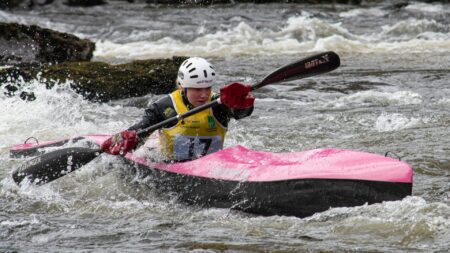 Athlete racing a kayak at the wild water racing selection event at Grandtully