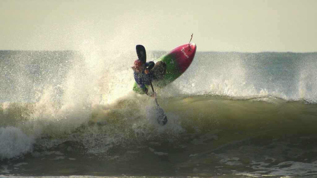 Mathew Lamont in the air after surfing a wave